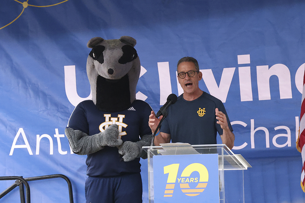 uci health hematologist oncologist and anti cancer challenge founder dr. richard van etten on stage with peter the anteater during the event