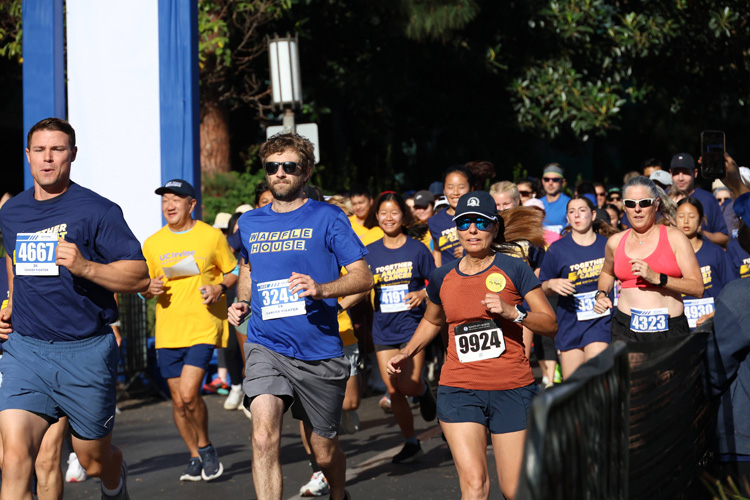 participants in the 2025 uc irvine anti-cancer challenge jog during the race portion of the event
