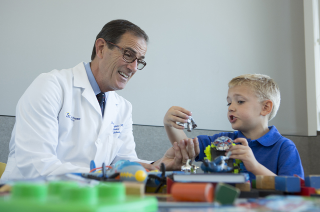 UCI Health eye specialist Dr. Robert Lingua talks with Brandon Hurt, 4, in the children's wing at the new Gavin Herbert Eye Institute