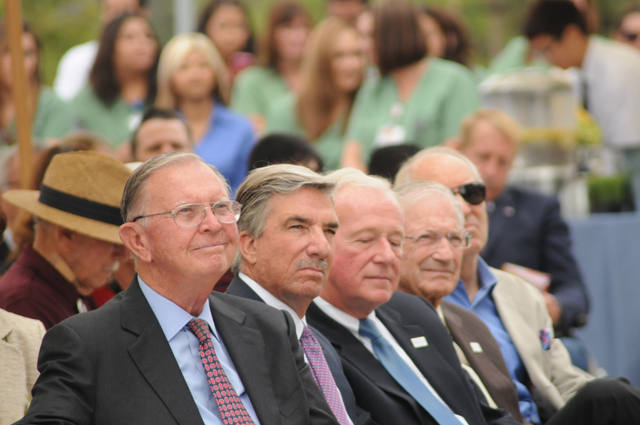 Orange County eye industry leaders Gavin Herbert, left, and Jim Mazzo, second from left, listen with UCI Health eye specialists Roger Steinert and Anthony Nesburn at opening ceremonies for the Gavin Herbert Eye Institute