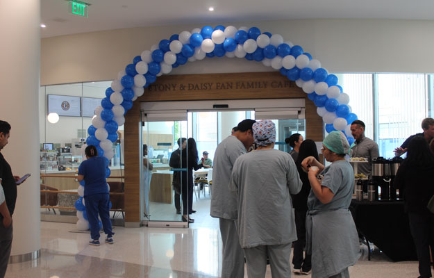 a blue and white baloon arch at the opening of the tony and daisy fan family cafe at the uci health chao family cancer center and ambulatory care building in Irvine