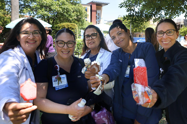 uci health co-worker hold popsicles at a beam signing event before the beam tops off uci health irvine