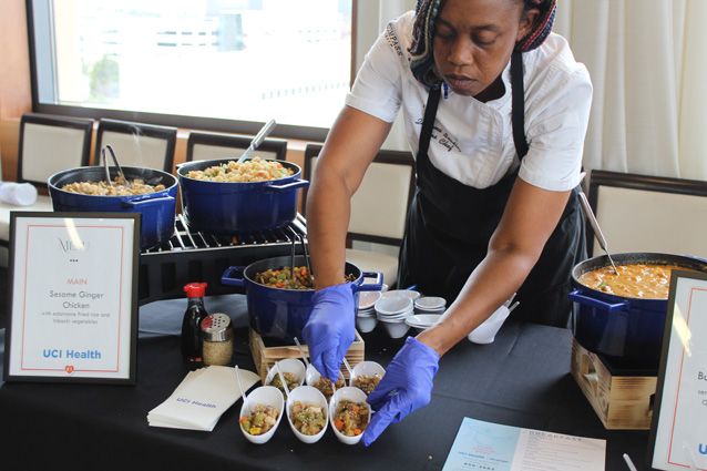 a server prepares some dishes at a menu tasting for UCI Health -- Irvine and UCI Medical Center in Orange