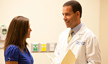 Dr. Robert E. Bristow, UCI Health gynecologic oncologist, talks with a patient.  