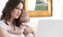 woman with postpartum depression on computer