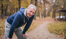 man with back pain smiling after exercise