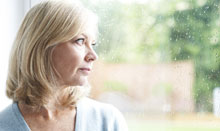 woman with seasonal affective disorder looking out window