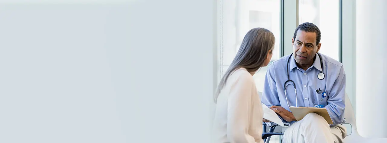 Clinician speaking to a patient