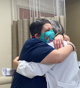 LeeAnn Brill hugs medical oncologist Dr. Rita Mehta