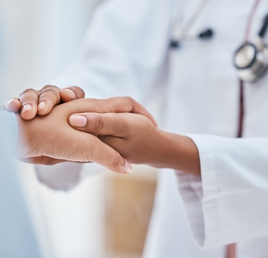 doctor holding patient hand