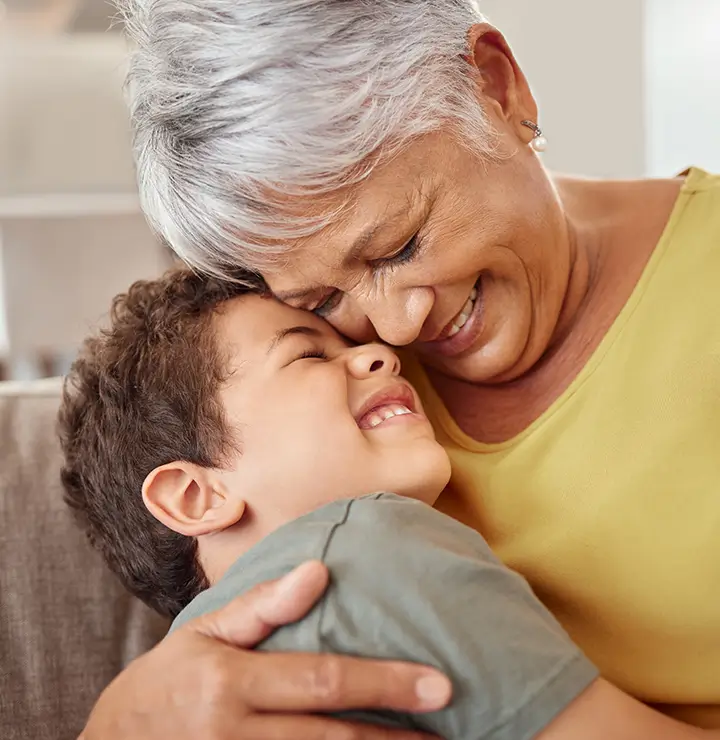 a elderly women and a child hug each other in a joyful embrace
