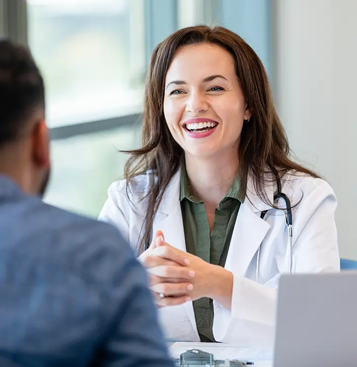 a doctor joyfully engages in conversation with a patient