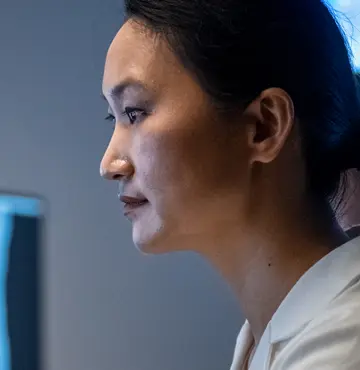 Female neurologist studies an MRI of the head