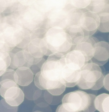 White bokeh bubbles on blue background