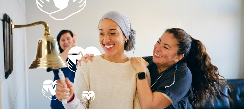 Young female cancer patient rings bell surrounded by smiling nurses